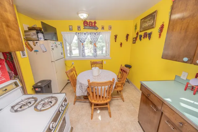 a dining room with a table and chairs