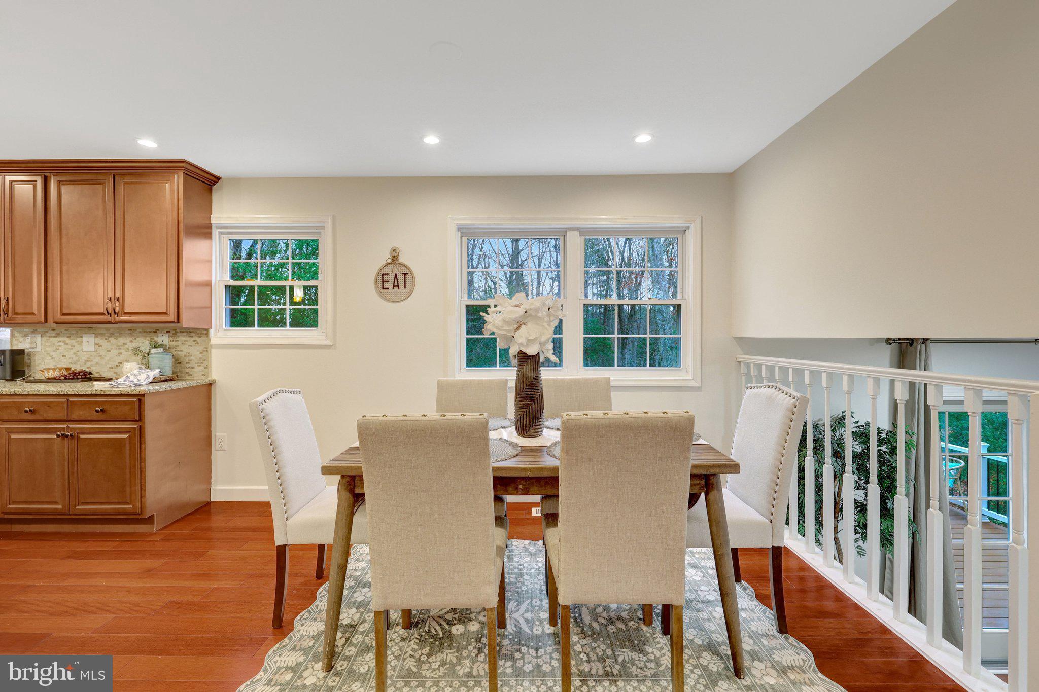 1827 Post Oak Trail Reston, VA 20191 - Photo 11 of 33 a view of a dining room with furniture and wooden floor