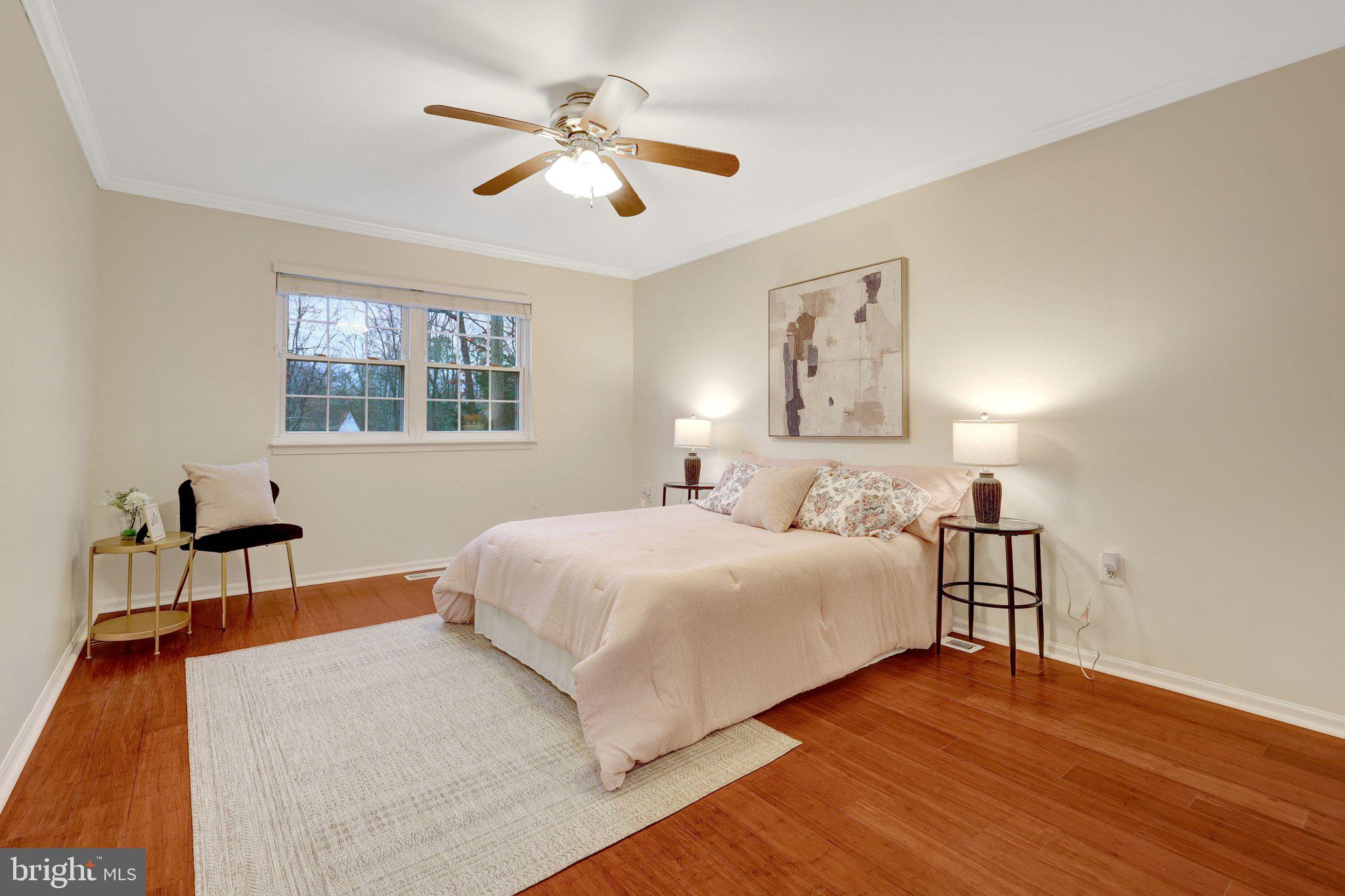 1827 Post Oak Trail Reston, VA 20191 - Photo 16 of 33 a bedroom with a large bed a chandelier and a window