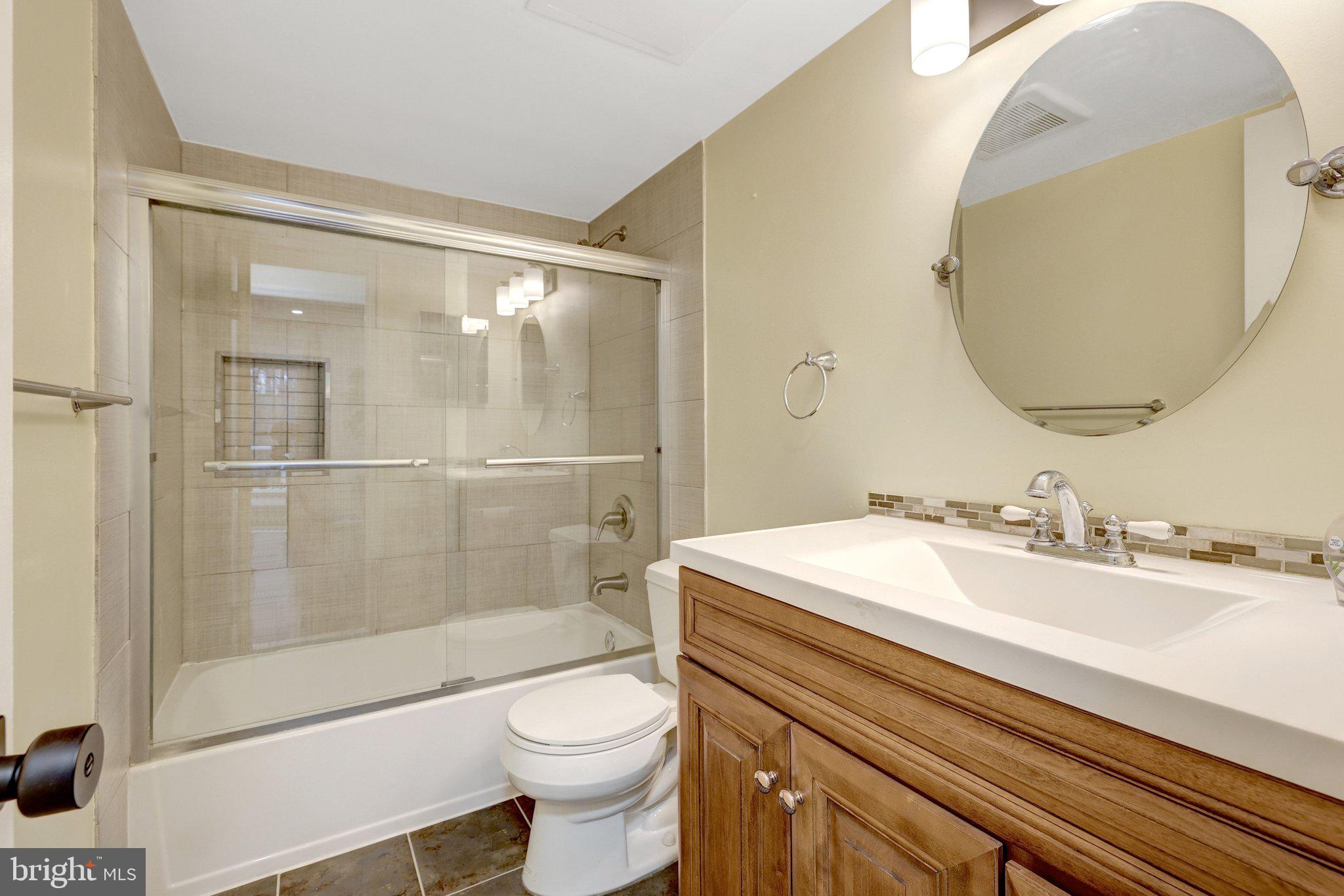 1827 Post Oak Trail Reston, VA 20191 - Photo 17 of 33 a bathroom with a sink a toilet and shower
