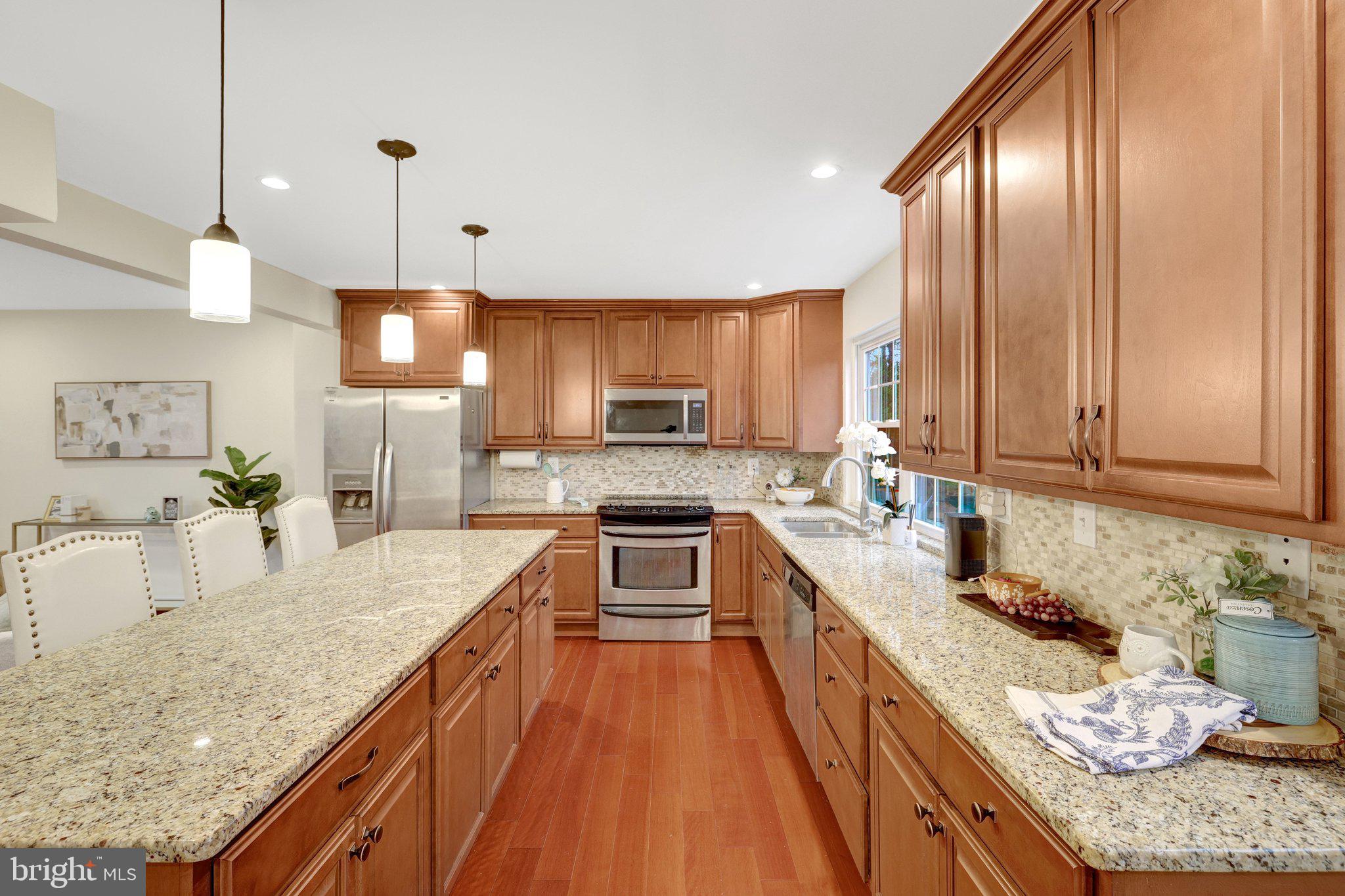 1827 Post Oak Trail Reston, VA 20191 - Photo 2 of 33 a large kitchen with granite countertop counter space a sink stainless steel appliances and cabinets