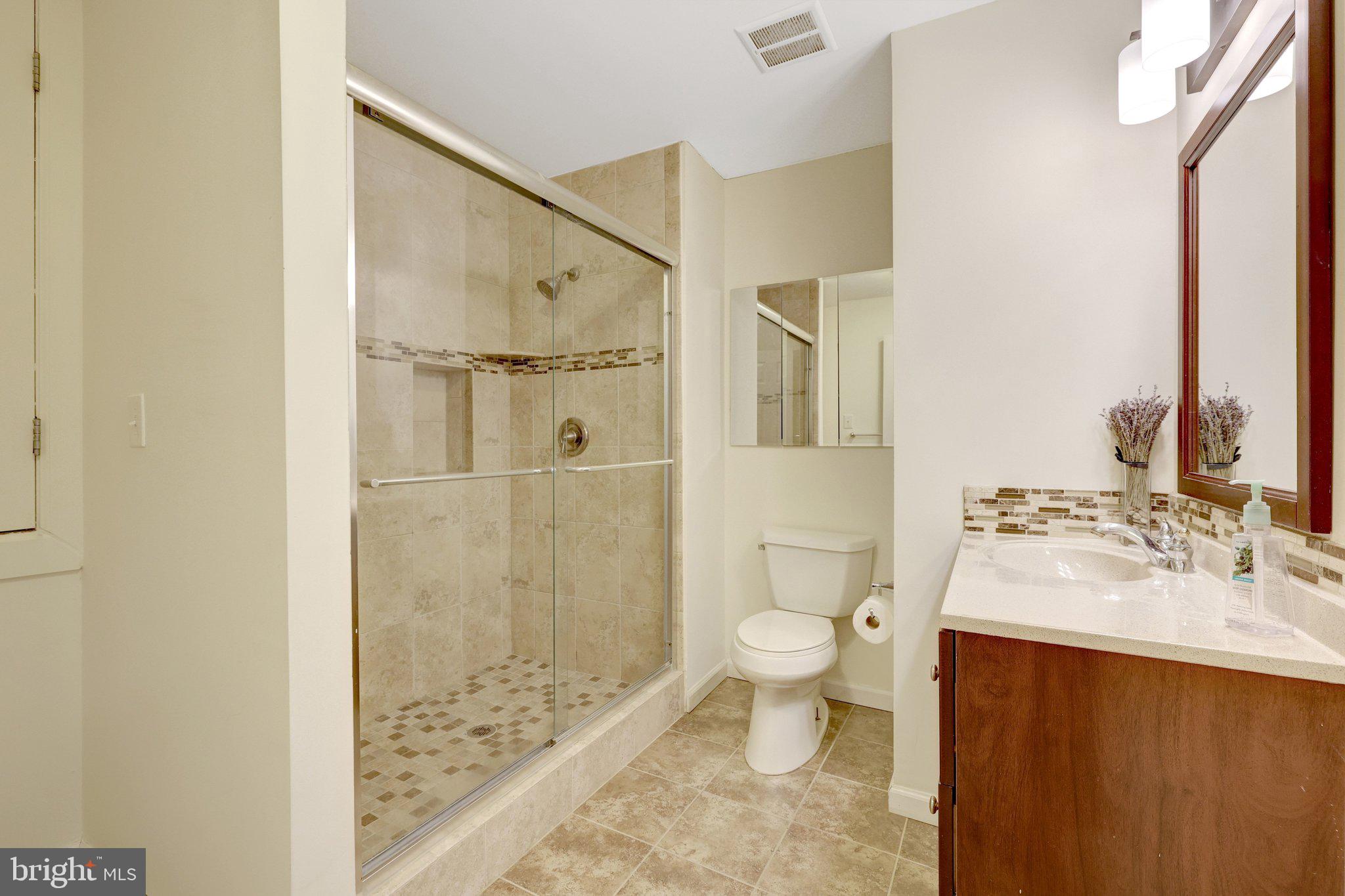 1827 Post Oak Trail Reston, VA 20191 - Photo 25 of 33 a bathroom with a sink a toilet and shower