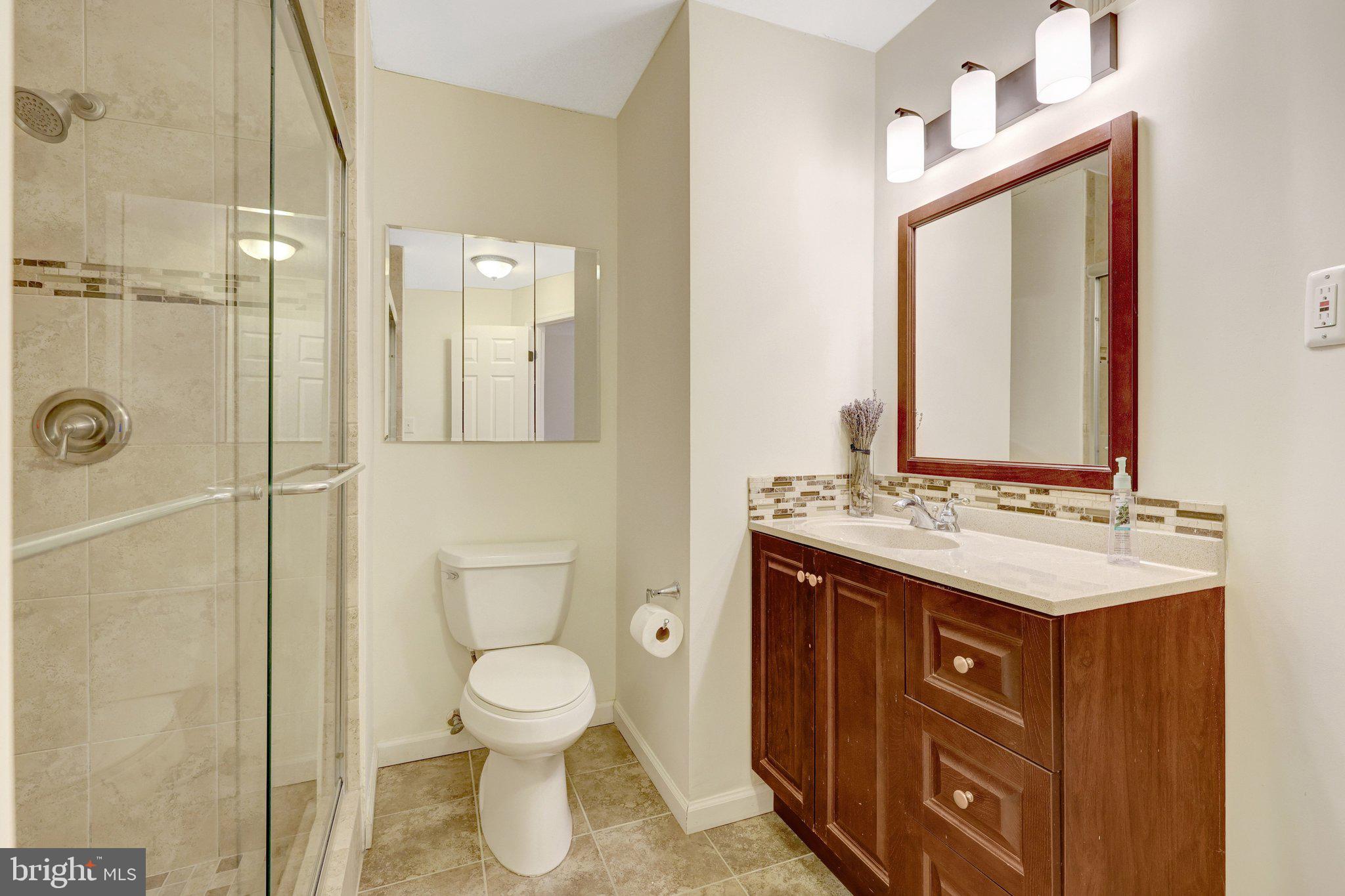 1827 Post Oak Trail Reston, VA 20191 - Photo 26 of 33 a bathroom with a toilet sink and mirror