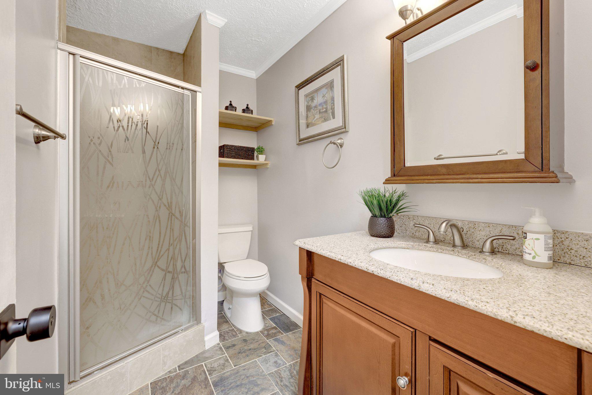 1827 Post Oak Trail Reston, VA 20191 - Photo 29 of 33 a bathroom with a granite countertop sink toilet and shower