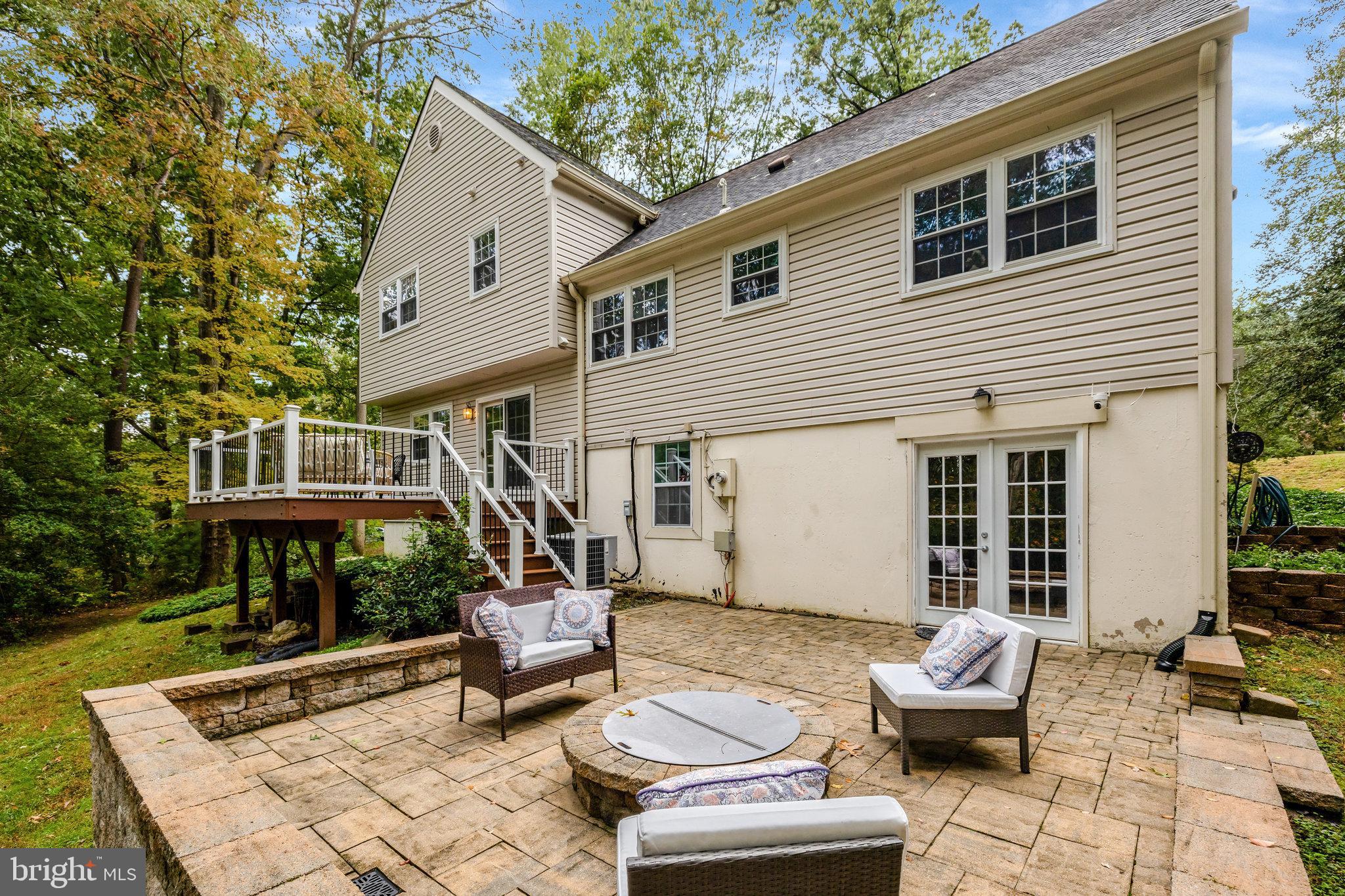 1827 Post Oak Trail Reston, VA 20191 - Photo 6 of 33 a view of a patio with couches table and chairs with wooden floor and fence