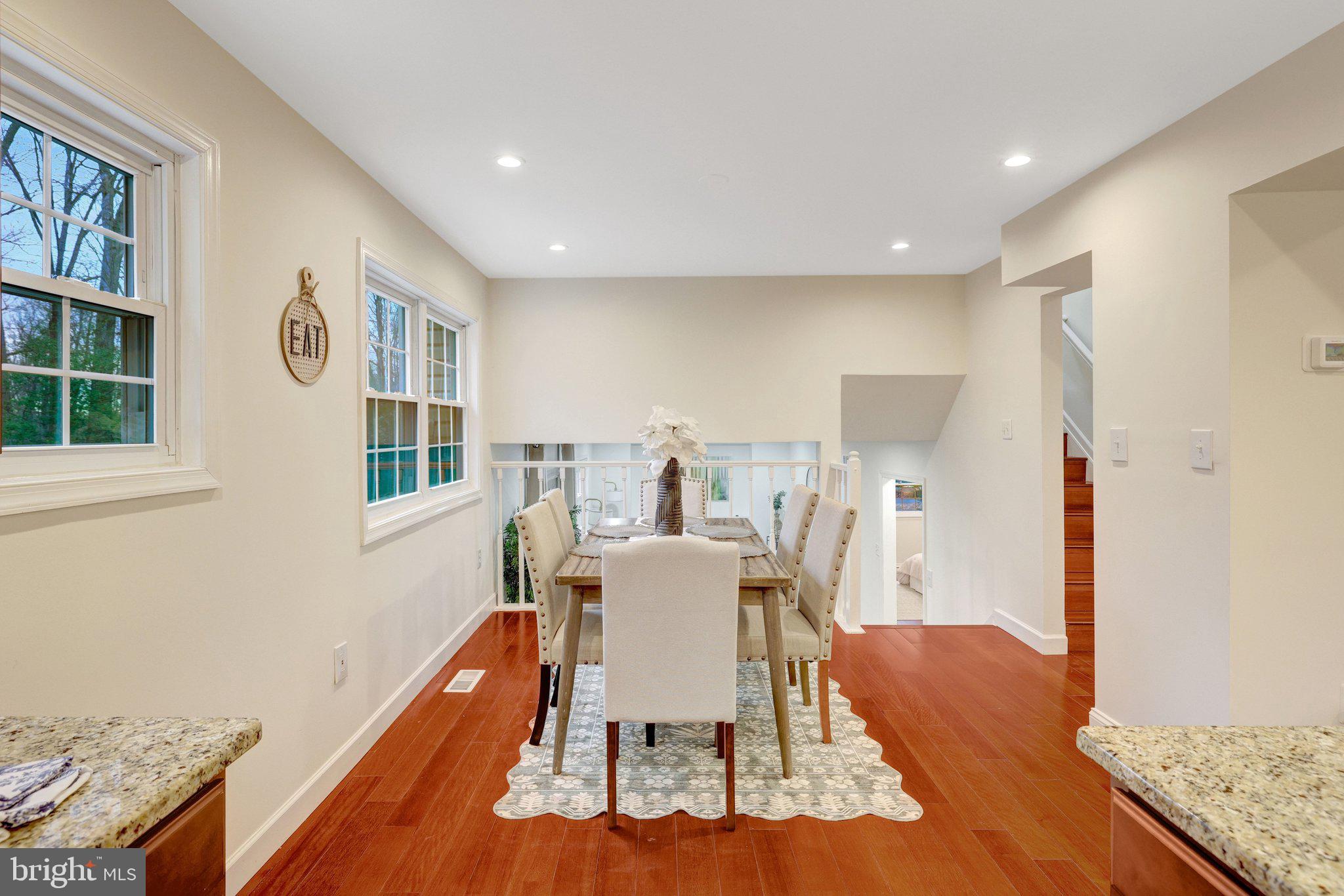 1827 Post Oak Trail Reston, VA 20191 - Photo 10 of 33 a dining room with wooden floor and white walls