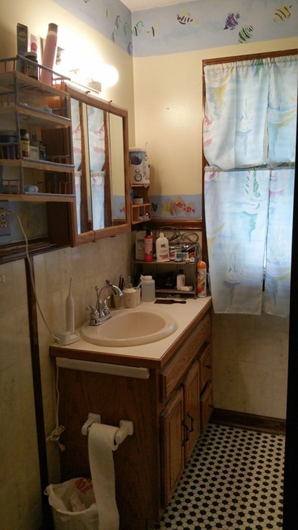 175 Lang Street Springfield, MA 01104 - Photo 10 of 28 a bathroom with a sink and a mirror