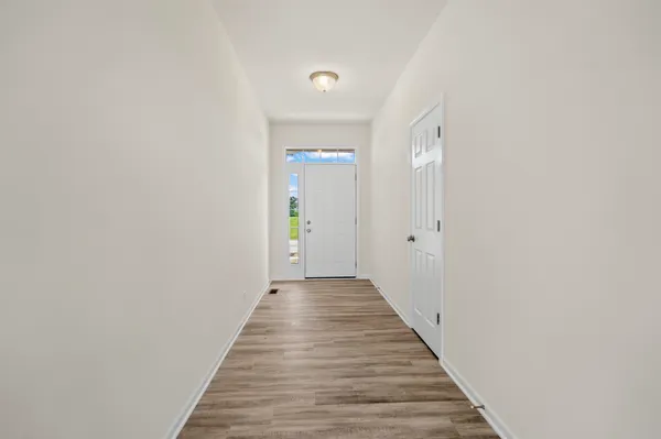 a view of a hallway with wooden floor