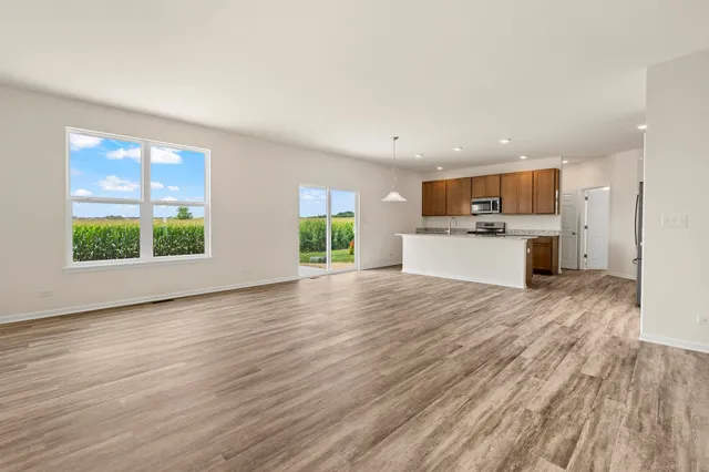a view of kitchen with kitchen island wooden floor and window
