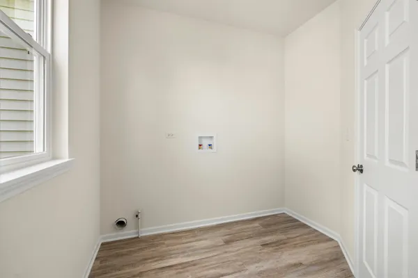 a view of a small space with wooden floor and a window