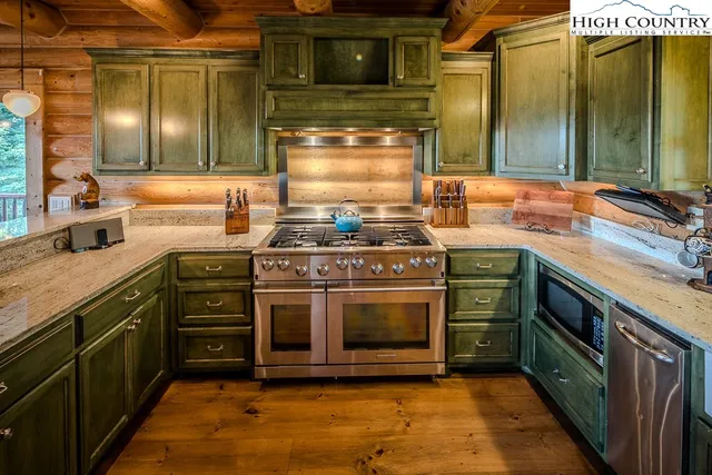 a kitchen with stainless steel appliances granite countertop a stove and a sink
