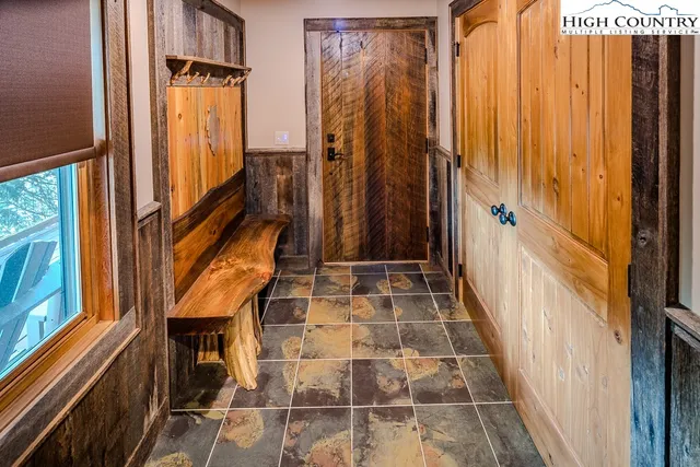 a kitchen with stainless steel appliances granite countertop a refrigerator a stove and a wooden cabinets