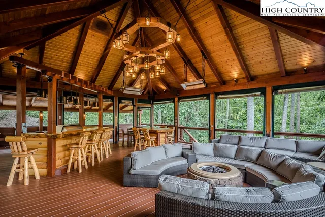 a living room with large windows and wooden floor