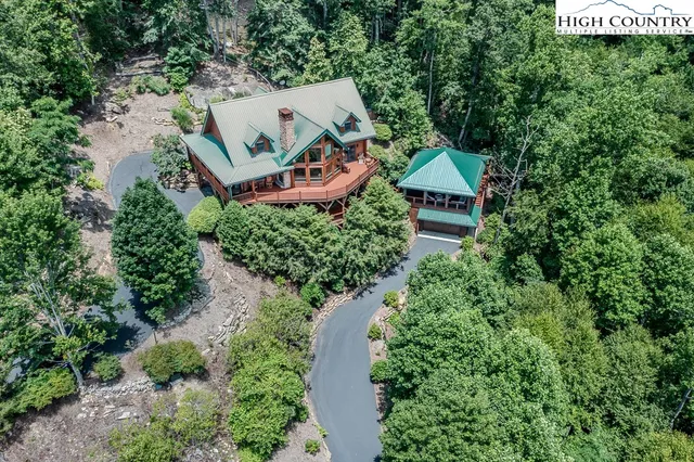 an aerial view of a house with garden space and street view