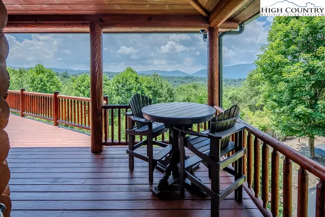 a view of a porch with furniture and wooden floor