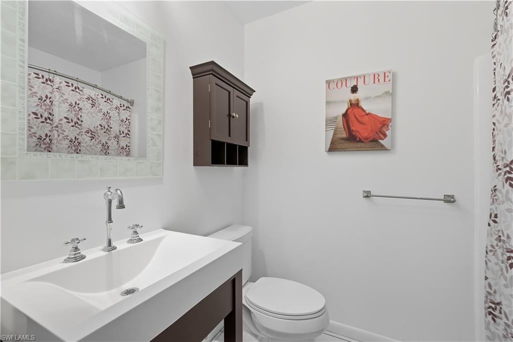 5356 16th Place Southwest, Unit G4 Naples, FL 34116 - Photo 17 of 23 a bathroom with a toilet sink and mirror