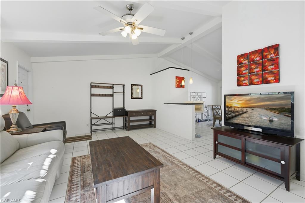 5356 16th Place Southwest, Unit G4 Naples, FL 34116 - Photo 6 of 23 a living room with furniture and a flat screen tv