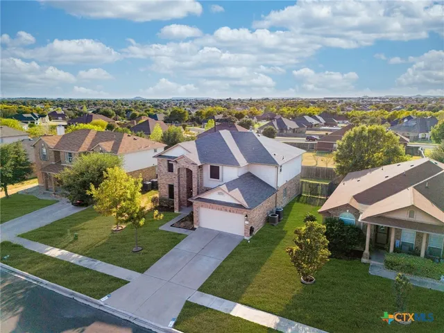 an aerial view of residential houses with outdoor space and swimming pool