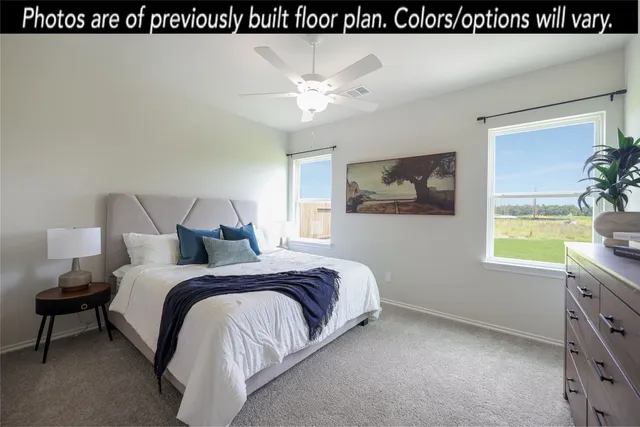 a spacious bedroom with a bed and window