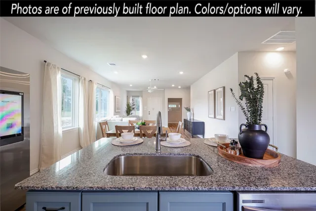 a kitchen with refrigerator and cabinets