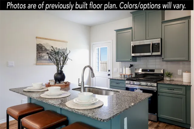a kitchen with granite countertop a sink and white appliances