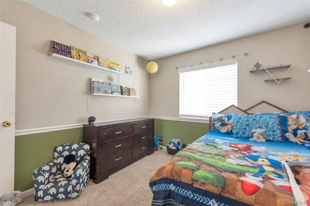 a bedroom with a bed and a dresser in it