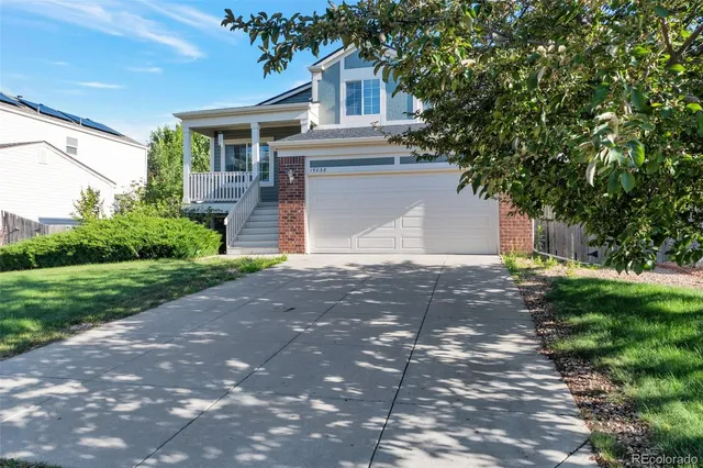 a front view of a house with a yard and a garage