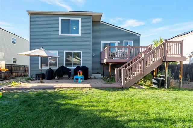 a view of a house with a yard and sitting area