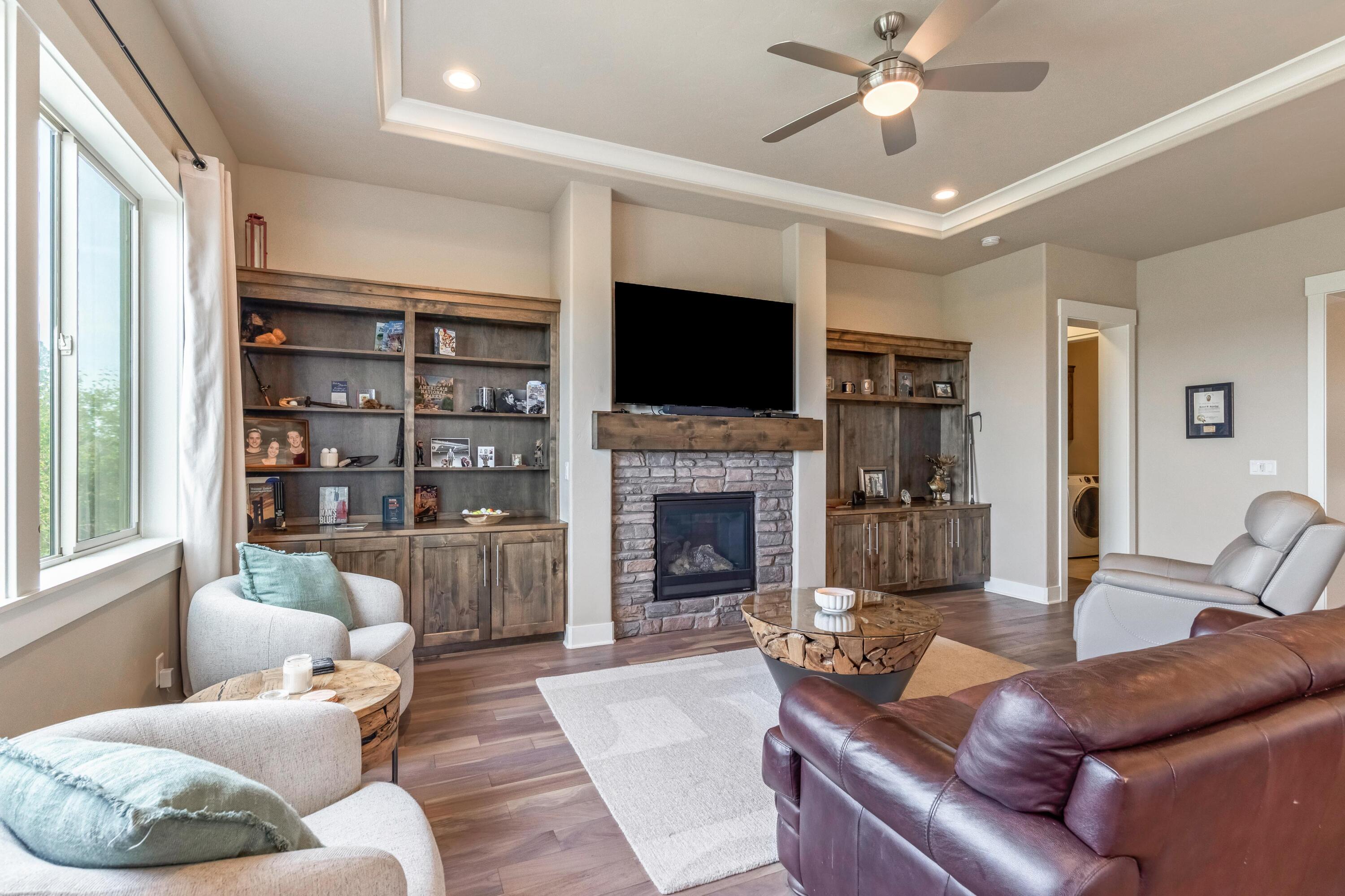 2375 Northwest Majestic Ridge Drive Bend, OR 97703 - Photo 4 of 28 a living room with furniture a fireplace and a flat screen tv