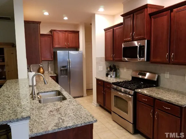 a view of a kitchen with wooden floor and a sink