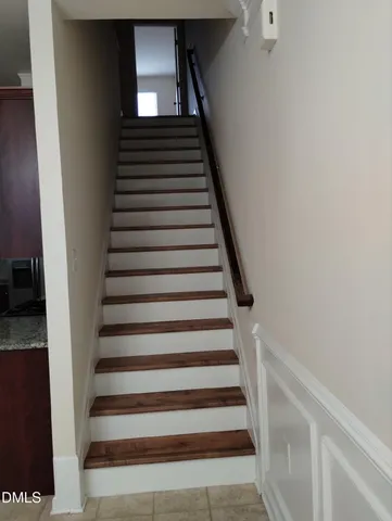 a view of a small space with wooden floor and a window