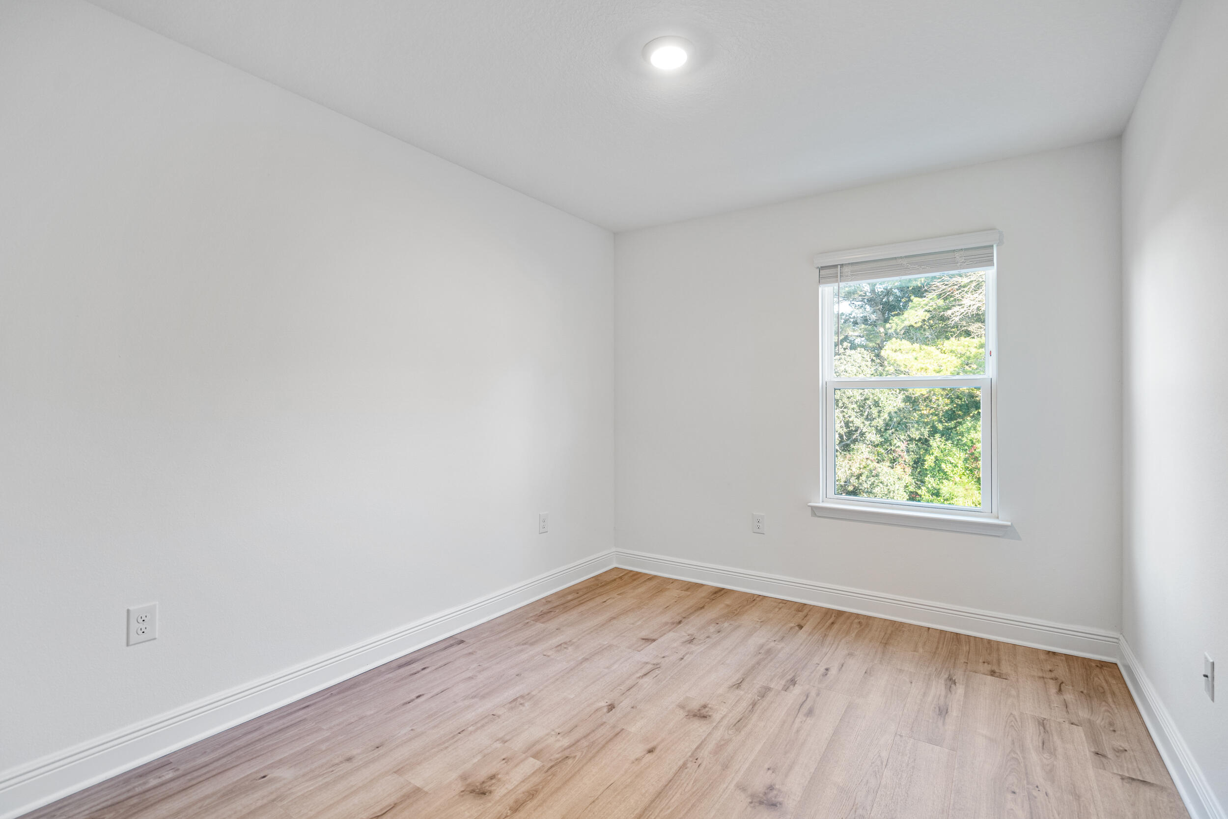 38 Redbird Loop Destin, FL 32541 - Photo 14 of 23 an empty room with wooden floor and windows