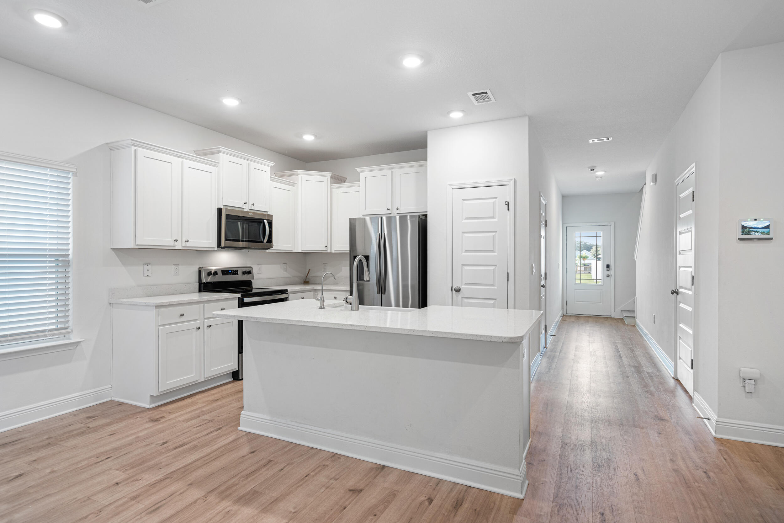 38 Redbird Loop Destin, FL 32541 - Photo 5 of 23 a large kitchen with cabinets stainless steel appliances a sink and a center island