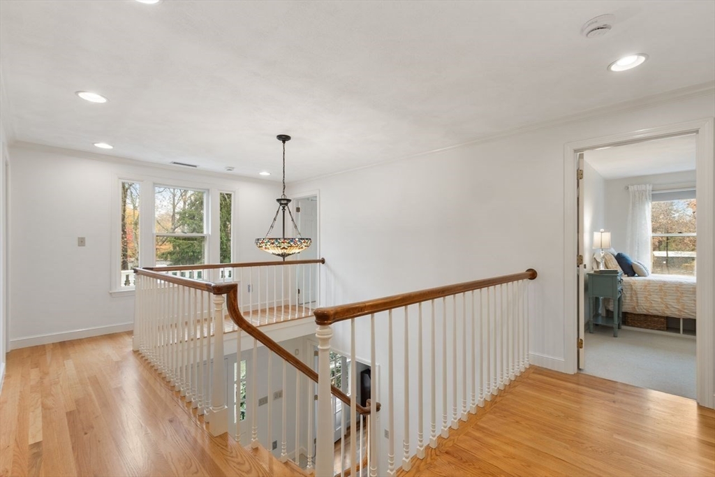 50 Hidden Road Andover, MA 01810 - Photo 24 of 42 a view of a hallway with wooden floor and staircase