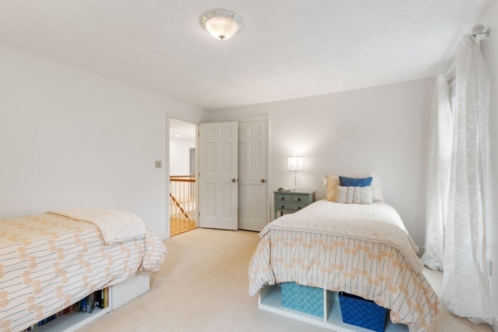 50 Hidden Road Andover, MA 01810 - Photo 26 of 42 a bedroom with a bed and a lamp