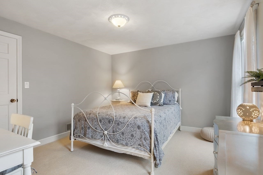 50 Hidden Road Andover, MA 01810 - Photo 27 of 42 a bedroom with a bed and a chair