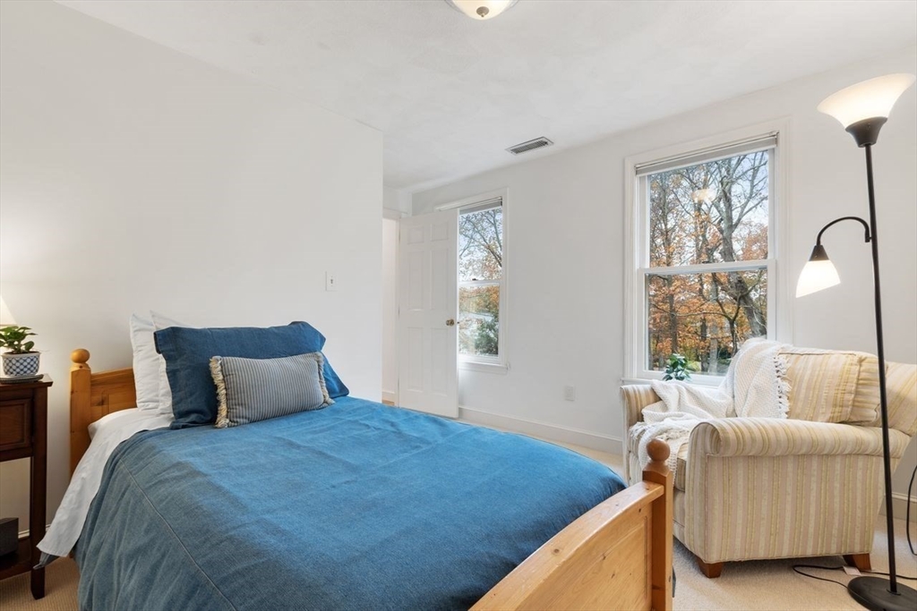 50 Hidden Road Andover, MA 01810 - Photo 30 of 42 a bedroom with a large bed and a window