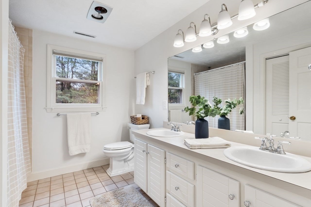 50 Hidden Road Andover, MA 01810 - Photo 31 of 42 a bathroom with a toilet a sink and mirror