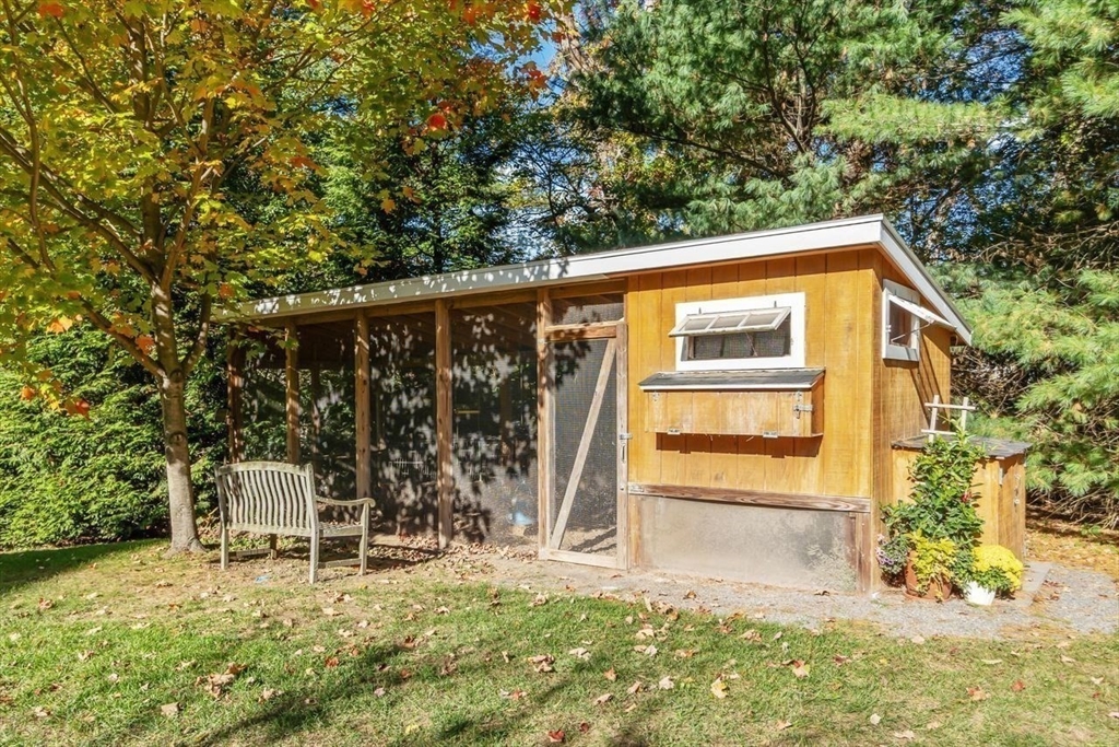 50 Hidden Road Andover, MA 01810 - Photo 34 of 42 a backyard of a house with table and chairs