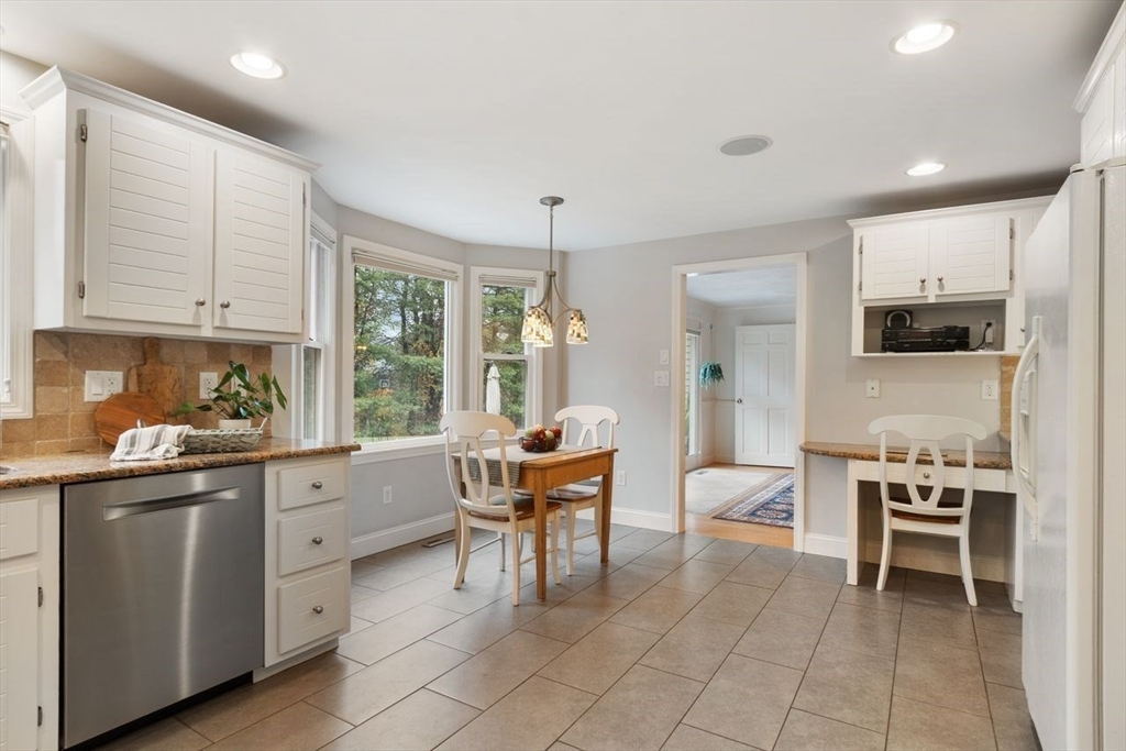 50 Hidden Road Andover, MA 01810 - Photo 8 of 42 a kitchen with stainless steel appliances kitchen island granite countertop a sink and cabinets