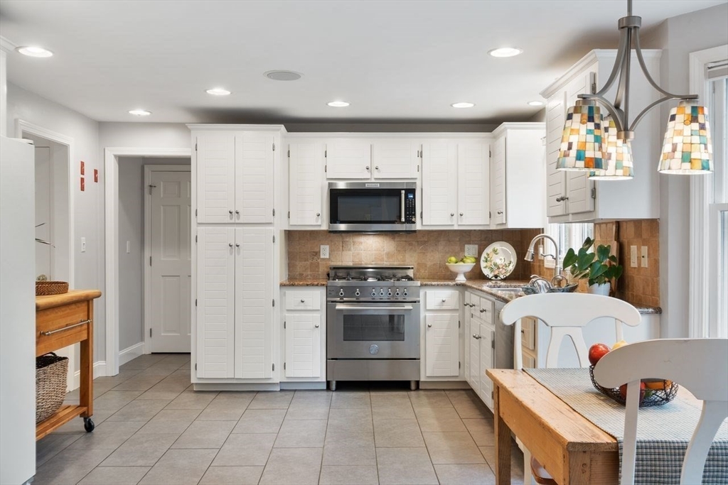 50 Hidden Road Andover, MA 01810 - Photo 9 of 42 a kitchen with stainless steel appliances granite countertop a stove and a refrigerator