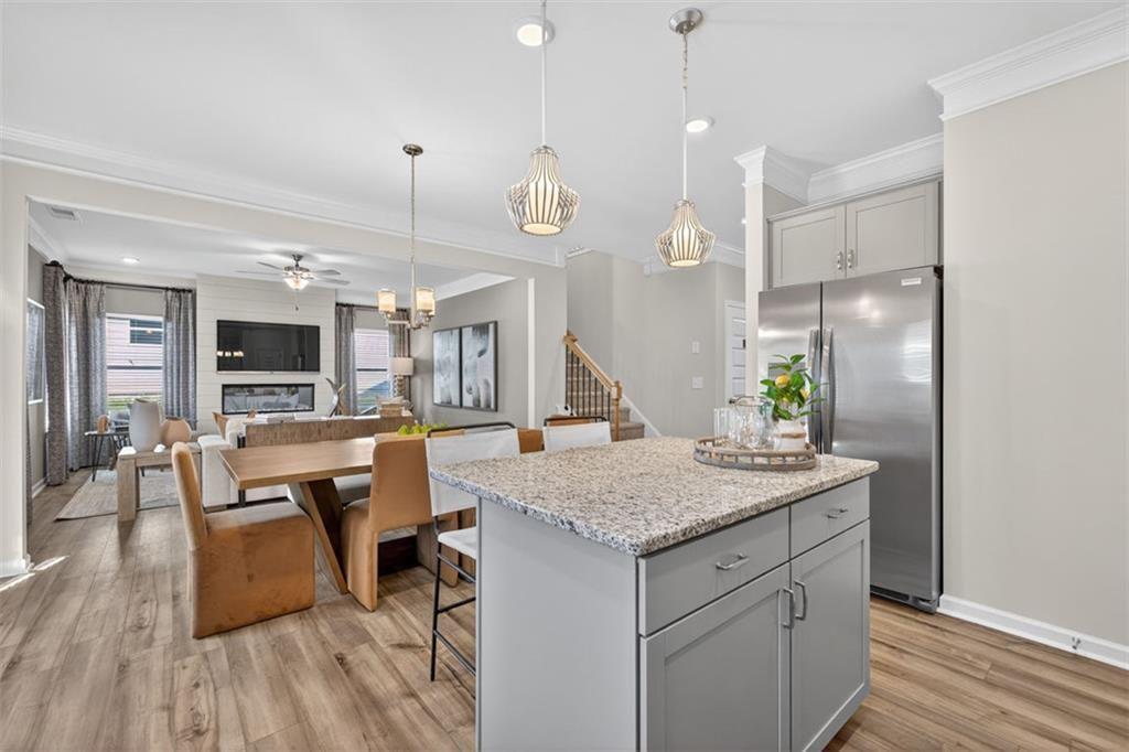 102 Rory Drive Calhoun, GA 30701 - Photo 12 of 38 a open kitchen with a table chairs and wooden floor