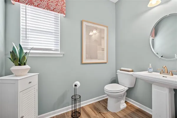 a bathroom with a toilet a sink and a mirror