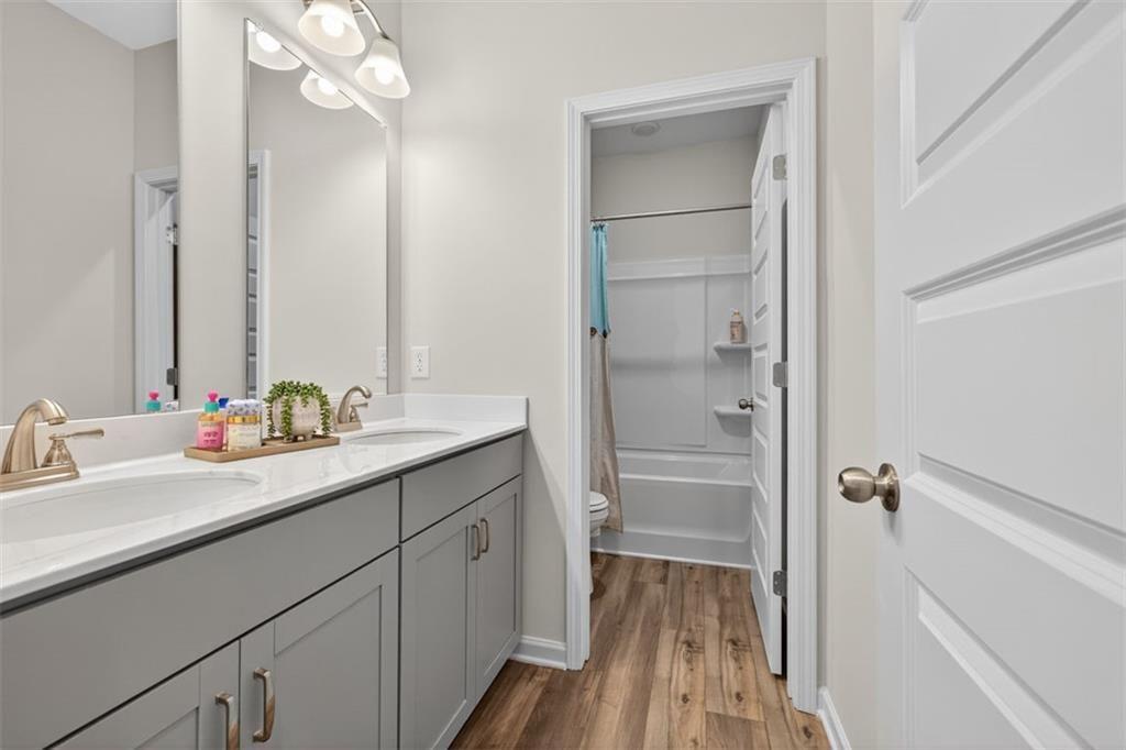 102 Rory Drive Calhoun, GA 30701 - Photo 25 of 38 a bathroom with a double vanity sink a mirror and a shower