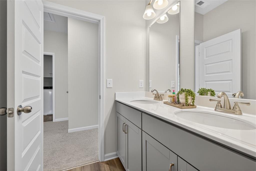 102 Rory Drive Calhoun, GA 30701 - Photo 27 of 38 a bathroom with a sink double vanity granite tub shower and a mirror