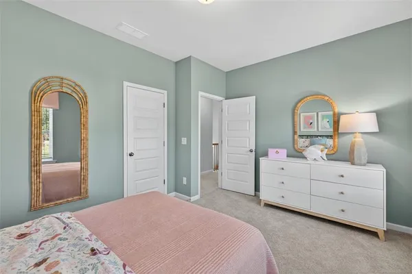a bedroom with a bed and a dresser