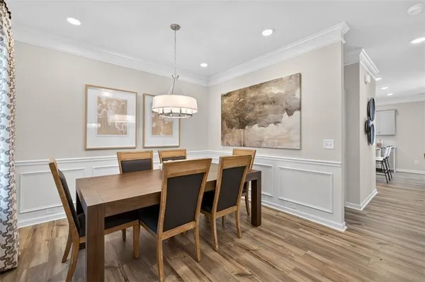 a view of a dining room with furniture window and wooden floor