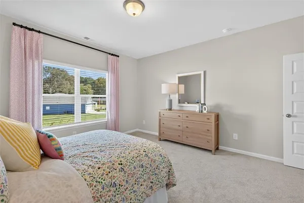 a bedroom with a bed and a dresser