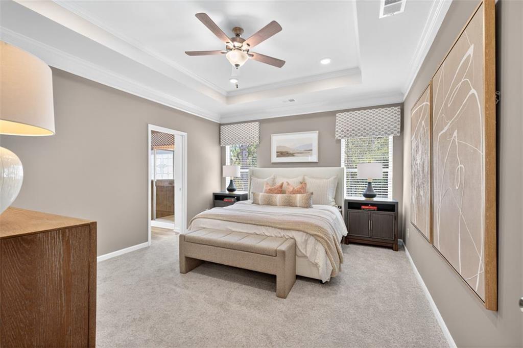 102 Rory Drive Calhoun, GA 30701 - Photo 33 of 38 a spacious bedroom with a bed a window and a lamp