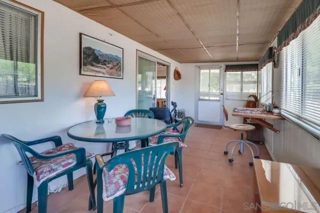 a living room with furniture a window and a table